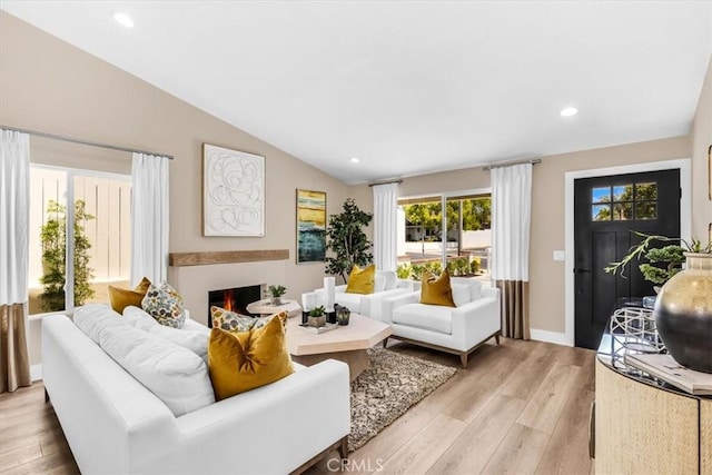 22461 Silver Spur, Lake Forest, CA 92630 - living room featuring light wood-type flooring, vaulted ceiling, recessed lighting, and a lit fireplace