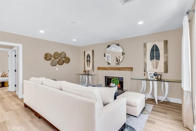 22461 Silver Spur, Lake Forest, CA 92630 - living room featuring light wood-style flooring, a glass covered fireplace, and recessed lighting