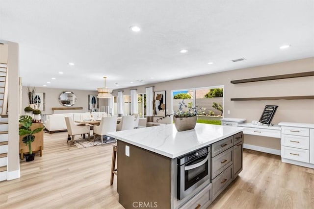 22461 Silver Spur, Lake Forest, CA 92630 - kitchen with open shelves, recessed lighting, light wood-style flooring, a center island, and an office area