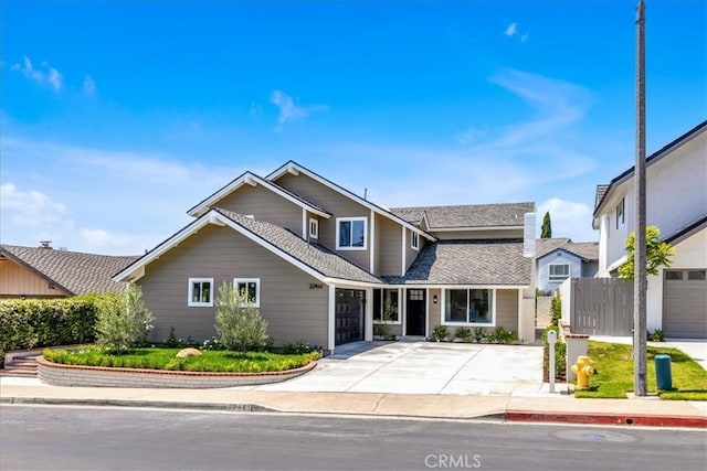 22461 Silver Spur, Lake Forest, CA 92630 - traditional-style house featuring driveway, roof with shingles, and a garage