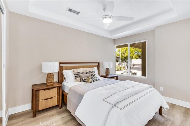 22461 Silver Spur, Lake Forest, CA 92630 - bedroom with a tray ceiling, wood finished floors, and a ceiling fan