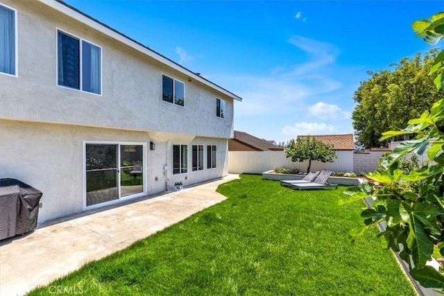 22461 Silver Spur, Lake Forest, CA 92630 - back of house with stucco siding, a storage unit, and a patio