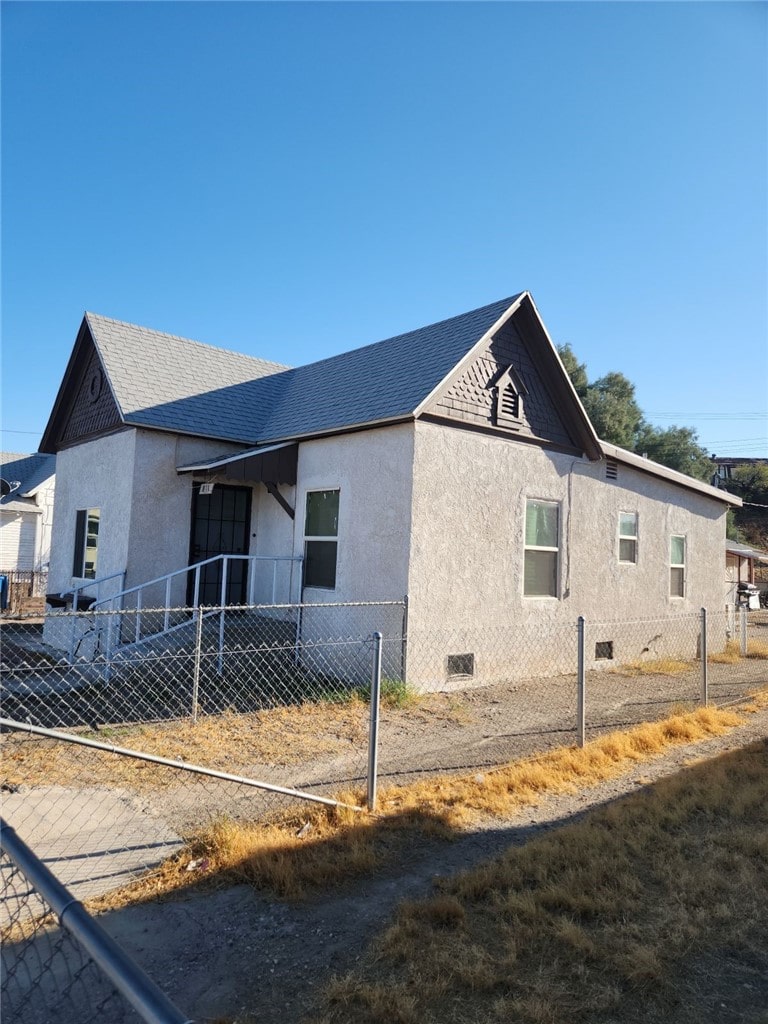 811 4th St, Needles, CA 92363 - view of front facade with stucco siding and a shingled roof
