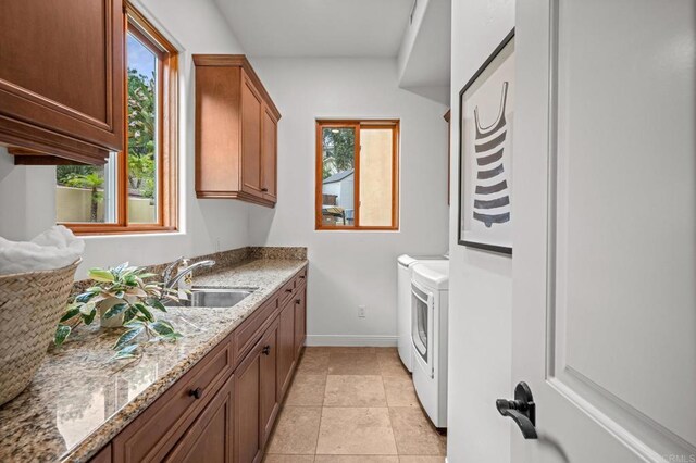 4149 Manchester Ave, Encinitas, CA 92024 - laundry room featuring separate washer and dryer, cabinet space, and light tile patterned flooring