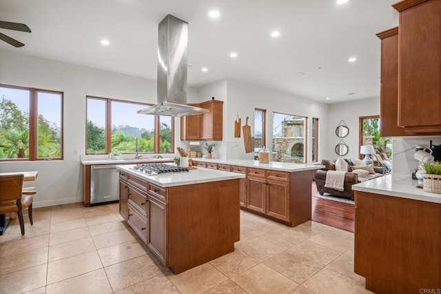 4149 Manchester Ave, Encinitas, CA 92024 - kitchen featuring appliances with stainless steel finishes, island range hood, light countertops, open floor plan, and brown cabinetry