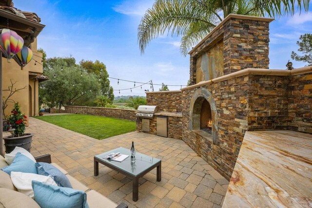 4149 Manchester Ave, Encinitas, CA 92024 - view of patio / terrace featuring exterior kitchen and an outdoor stone fireplace