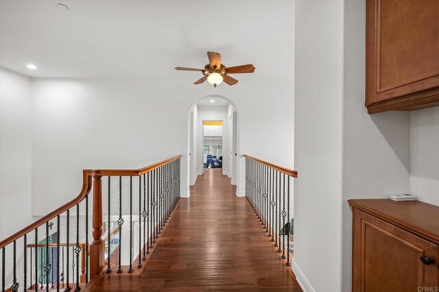 4149 Manchester Ave, Encinitas, CA 92024 - corridor with dark wood finished floors, arched walkways, recessed lighting, and an upstairs landing