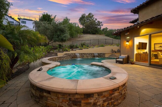 4149 Manchester Ave, Encinitas, CA 92024 - pool at dusk featuring an in-ground hot tub and a patio area