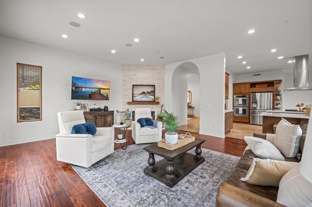 4149 Manchester Ave, Encinitas, CA 92024 - living room featuring arched walkways, wood finished floors, and recessed lighting