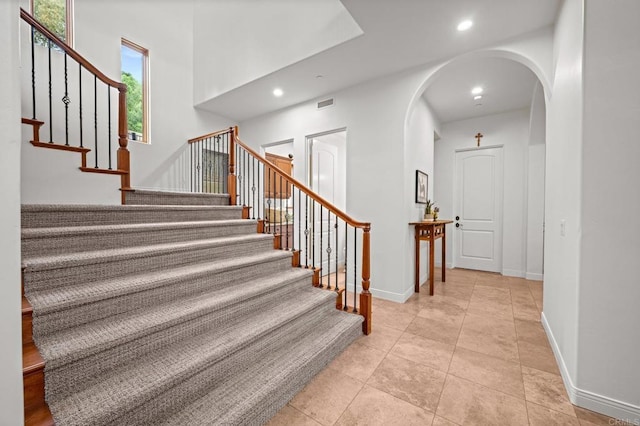 4149 Manchester Ave, Encinitas, CA 92024 - stairs featuring arched walkways, recessed lighting, and tile patterned floors