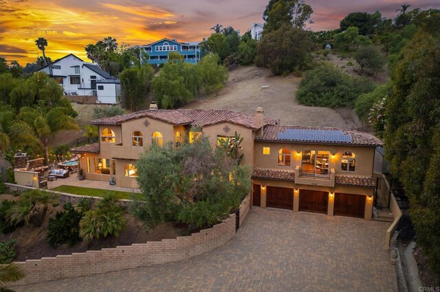 4149 Manchester Ave, Encinitas, CA 92024 - view of front of property with a balcony, an attached garage, a tile roof, stucco siding, and a chimney