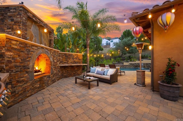 4149 Manchester Ave, Encinitas, CA 92024 - patio terrace at dusk featuring a patio area and an outdoor living space with a fireplace