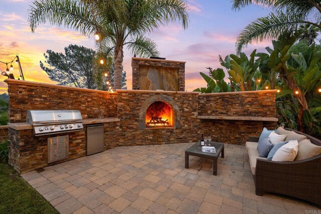 4149 Manchester Ave, Encinitas, CA 92024 - patio terrace at dusk with a patio, area for grilling, and an outdoor living space with a fireplace