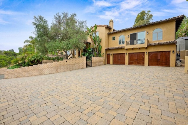 4149 Manchester Ave, Encinitas, CA 92024 - view of front facade featuring a balcony, a garage, stucco siding, and driveway