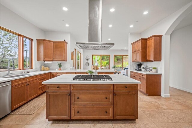4149 Manchester Ave, Encinitas, CA 92024 - kitchen with appliances with stainless steel finishes, island range hood, recessed lighting, a center island, and brown cabinets