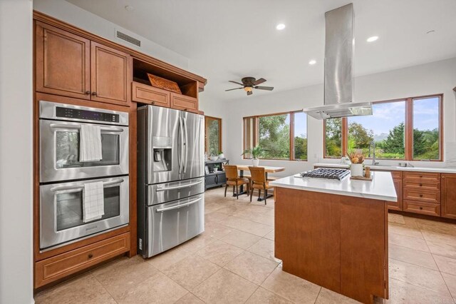 4149 Manchester Ave, Encinitas, CA 92024 - kitchen with stainless steel appliances, light countertops, open shelves, a center island, and brown cabinetry