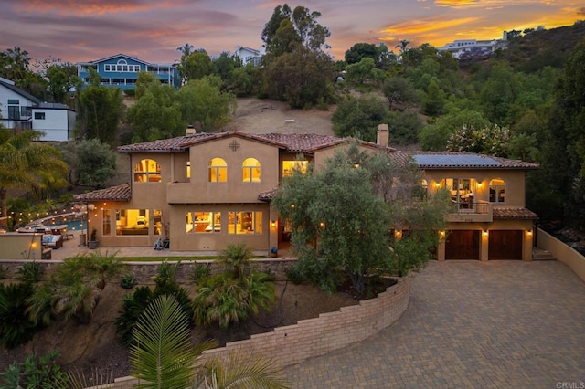 4149 Manchester Ave, Encinitas, CA 92024 - mediterranean / spanish-style home with a balcony, an attached garage, a chimney, and stucco siding