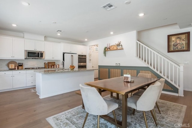 874 Royal Knight Trl, Redlands, CA 92374 - dining space with stairs, light wood finished floors, and recessed lighting