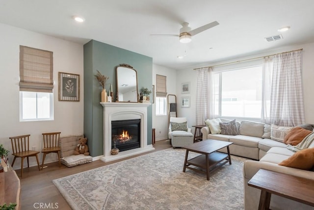 874 Royal Knight Trl, Redlands, CA 92374 - living area with plenty of natural light, wood finished floors, a glass covered fireplace, ceiling fan, and recessed lighting