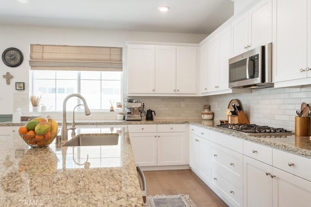 874 Royal Knight Trl, Redlands, CA 92374 - kitchen with appliances with stainless steel finishes, white cabinetry, backsplash, and recessed lighting