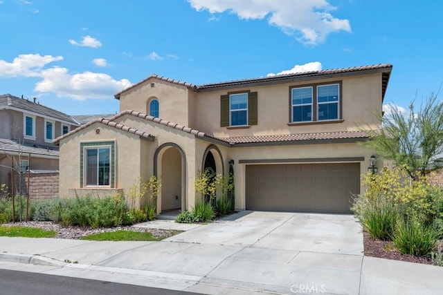 874 Royal Knight Trl, Redlands, CA 92374 - mediterranean / spanish-style house with stucco siding, driveway, a tiled roof, and an attached garage