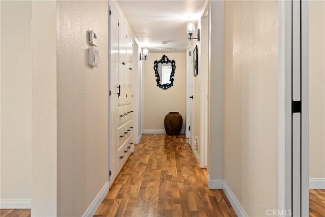 7735 Del Rio Rd, Atascadero, CA 93422 - hallway with light wood-style floors and baseboards