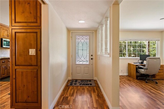 7735 Del Rio Rd, Atascadero, CA 93422 - doorway featuring wood finished floors and a desk