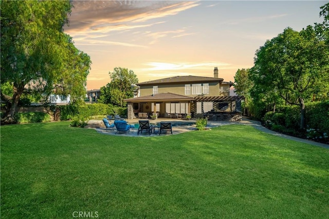 2937 Arboridge Ct, Fullerton, CA 92835 - back of property at dusk with a pergola, a patio, a lawn, outdoor lounge area, and an outdoor pool