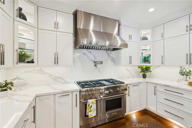 2937 Arboridge Ct, Fullerton, CA 92835 - kitchen with wall chimney exhaust hood, double oven range, white cabinetry, glass insert cabinets, and tasteful backsplash
