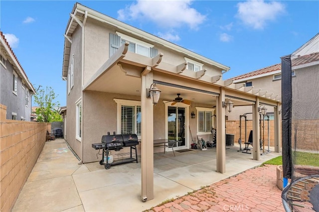 16315 Yorba Linda Ln, Fontana, CA 92336 - rear view of house with stucco siding, a ceiling fan, a fenced backyard, and a patio area