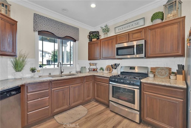 16315 Yorba Linda Ln, Fontana, CA 92336 - kitchen featuring stainless steel appliances, backsplash, light wood finished floors, light stone counters, and ornamental molding