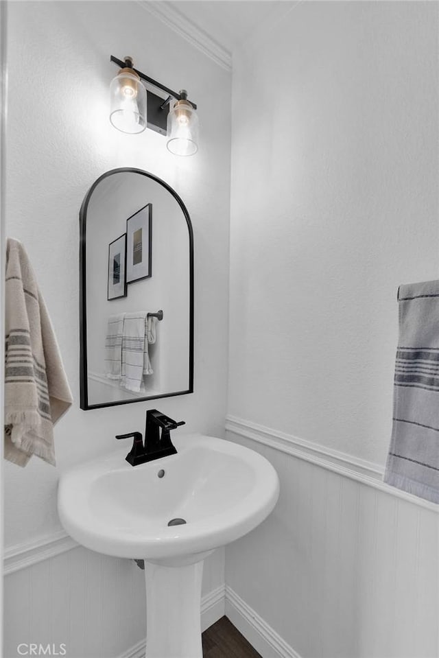 16315 Yorba Linda Ln, Fontana, CA 92336 - bathroom featuring crown molding, a wainscoted wall, and wood finished floors