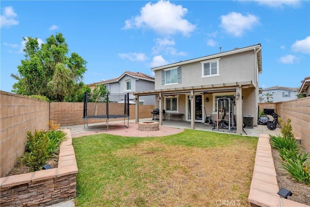 16315 Yorba Linda Ln, Fontana, CA 92336 - back of property with stucco siding, a patio area, an outdoor fire pit, a fenced backyard, and a trampoline