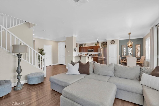 16315 Yorba Linda Ln, Fontana, CA 92336 - living room featuring stairs, recessed lighting, wood finished floors, and crown molding