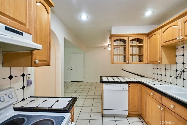212 S Kraemer Blvd Unit 1205, Placentia, CA 92870 - kitchen featuring white appliances, under cabinet range hood, tasteful backsplash, tile counters, and glass insert cabinets