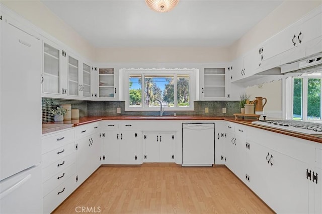 252 W 15th St, Upland, CA 91786 - kitchen featuring white appliances, tasteful backsplash, light wood-style flooring, dark countertops, and white cabinetry