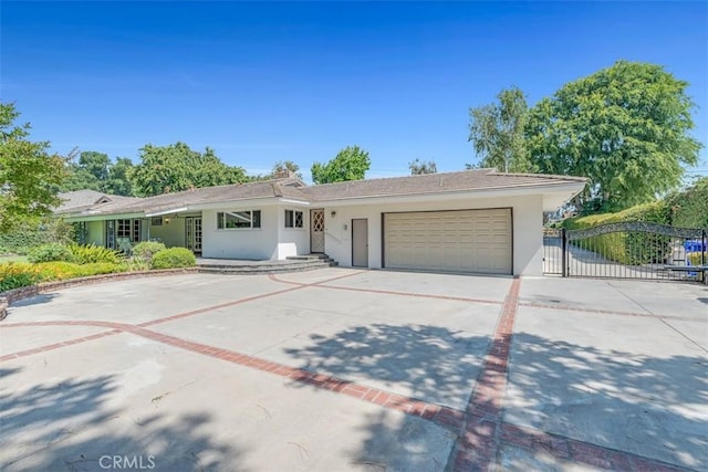 252 W 15th St, Upland, CA 91786 - ranch-style house featuring an attached garage, driveway, stucco siding, and a gate