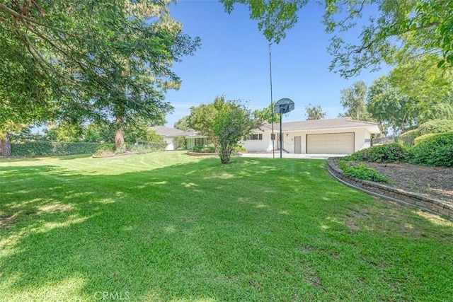 252 W 15th St, Upland, CA 91786 - view of green lawn featuring an attached garage and driveway