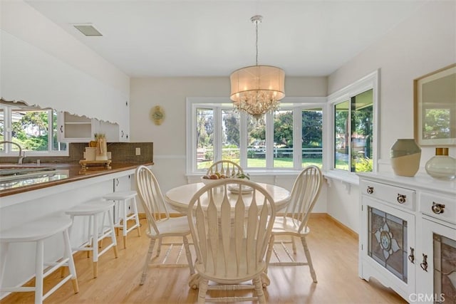 252 W 15th St, Upland, CA 91786 - dining room with plenty of natural light, a chandelier, and light wood finished floors