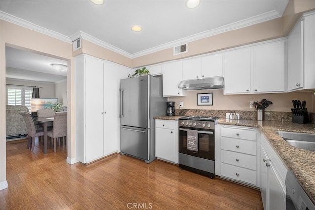 9676 Bloomfield St, Cypress, CA 90630 - kitchen with stainless steel appliances, under cabinet range hood, crown molding, white cabinets, and light wood-style floors