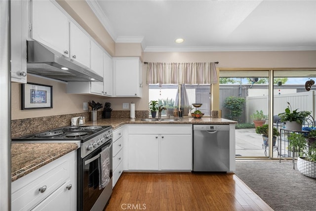 9676 Bloomfield St, Cypress, CA 90630 - kitchen featuring stainless steel appliances, under cabinet range hood, ornamental molding, white cabinetry, and wood finished floors