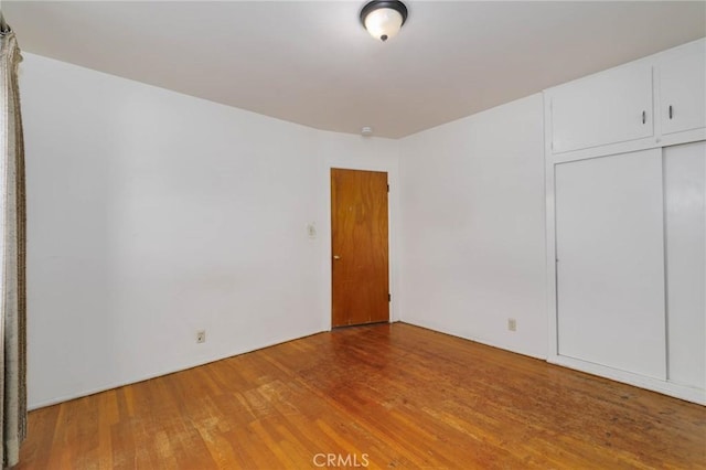 11701 Roseglen St, El Monte, CA 91732 - unfurnished bedroom featuring light wood finished floors and a closet