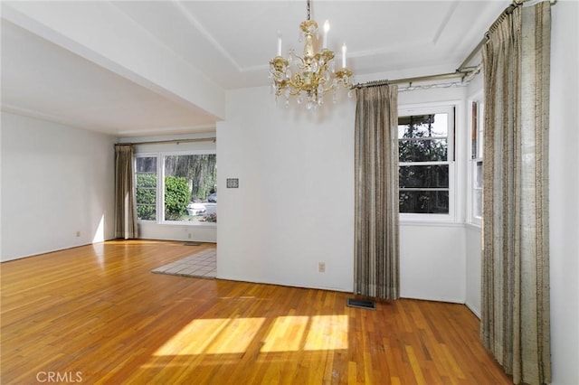 11701 Roseglen St, El Monte, CA 91732 - spare room featuring wood finished floors and a chandelier