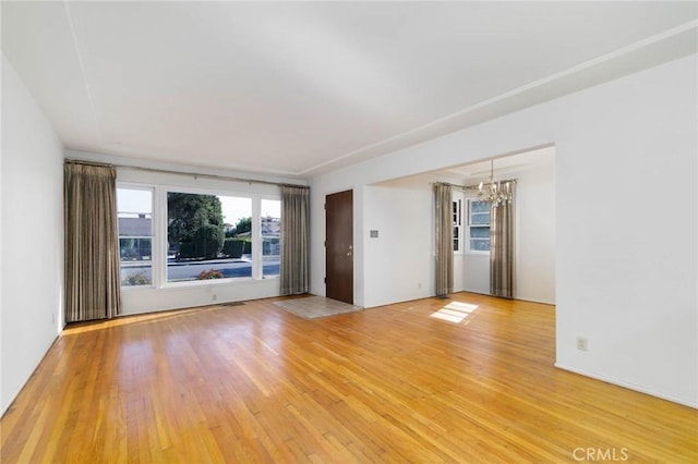 11701 Roseglen St, El Monte, CA 91732 - unfurnished room featuring a chandelier and light wood-type flooring