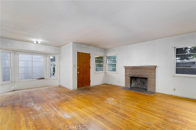 11701 Roseglen St, El Monte, CA 91732 - unfurnished living room featuring a fireplace with flush hearth and wood finished floors