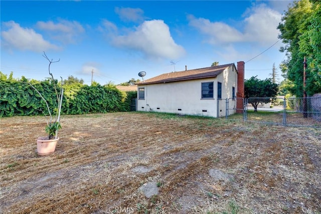 11701 Roseglen St, El Monte, CA 91732 - back of property featuring a gate, crawl space, and stucco siding