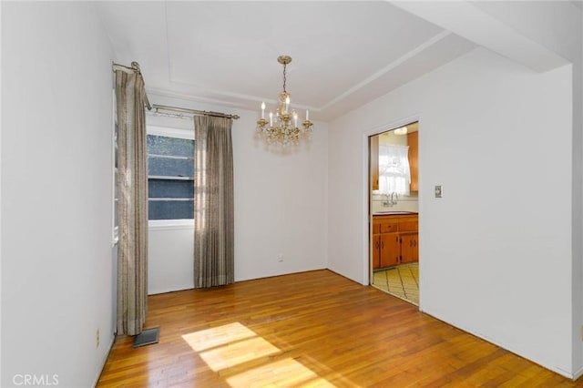 11701 Roseglen St, El Monte, CA 91732 - unfurnished room featuring a chandelier and wood finished floors
