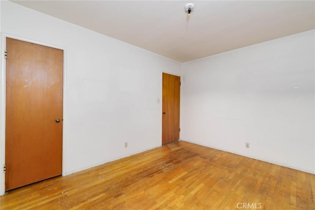 11701 Roseglen St, El Monte, CA 91732 - spare room with light wood finished floors and a pendent fire sprinkler