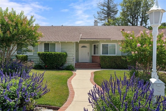 9508 Jellico Ave, Northridge, CA 91325 - view of front facade featuring a front yard, roof with shingles, and brick siding