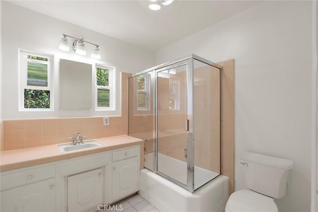 9508 Jellico Ave, Northridge, CA 91325 - full bath featuring vanity, tasteful backsplash, bath / shower combo with glass door, and tile patterned floors